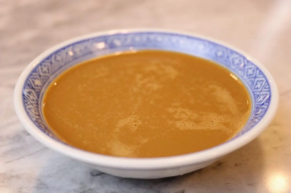 Teppanyaki mustard dipping sauce in a blue-rimmed bowl.