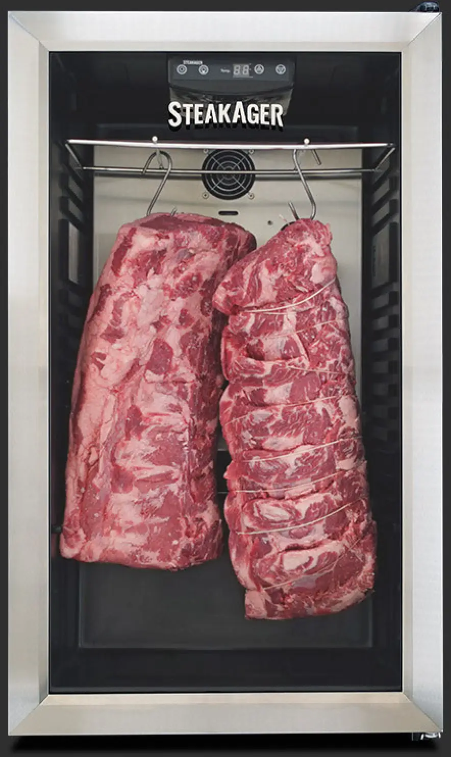 Two large beef cuts hanging inside a SteakAger dry-aging unit.
