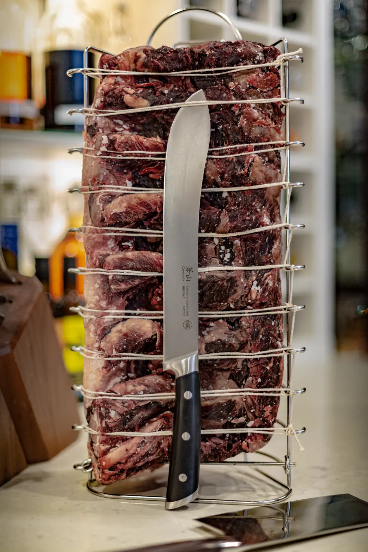 knife cutting through trussed meat