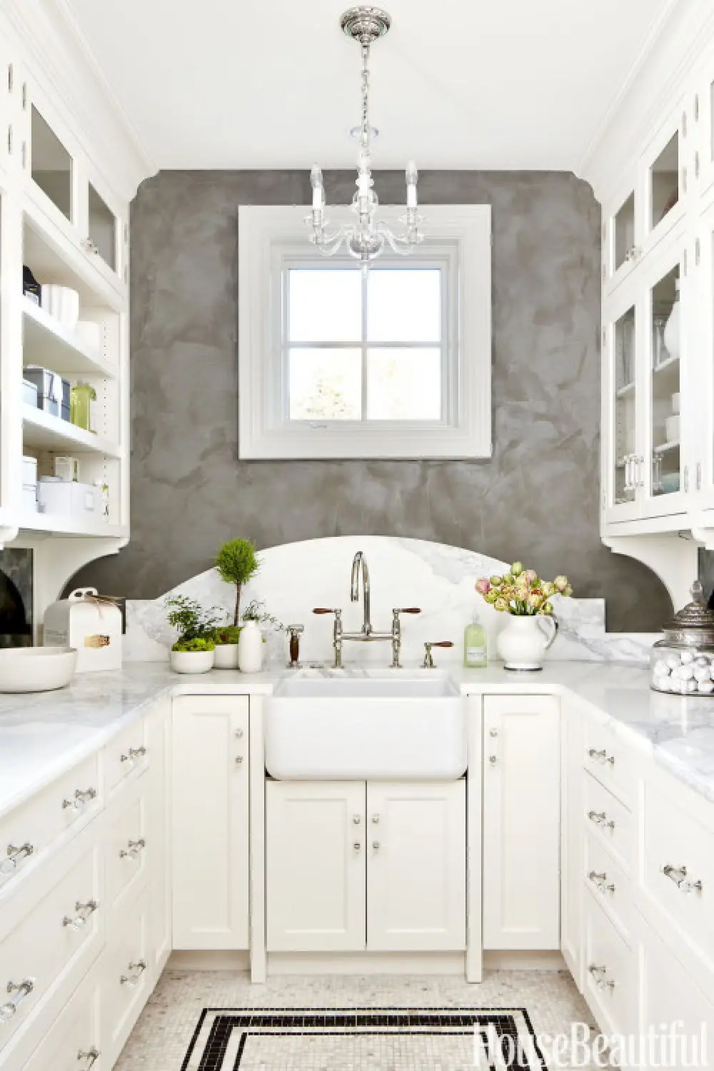 white kitchen with marble scalloped backsplash