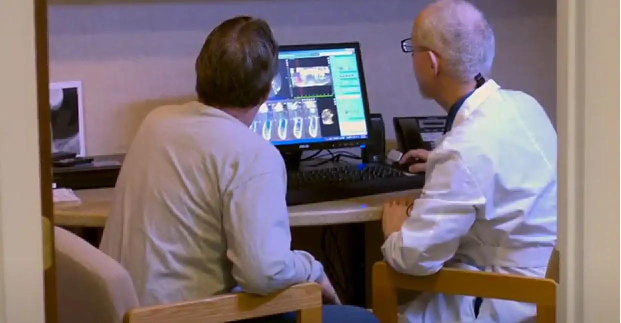 dr hirschfield with a patient reviewing xrays