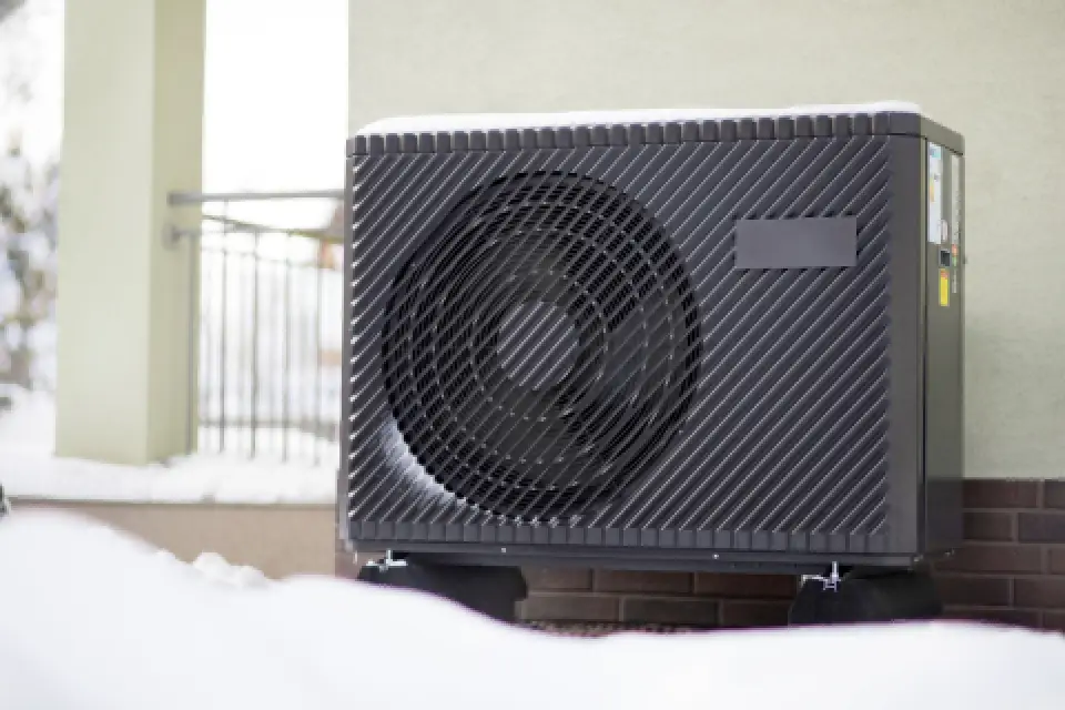 Heat pump unit in winter with snow