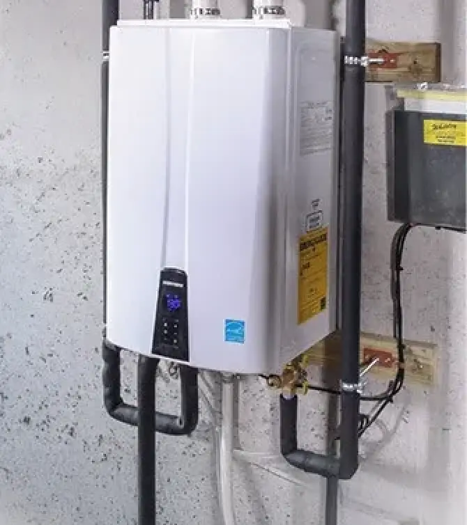 a white wall mounted tankless water heater with black pipes