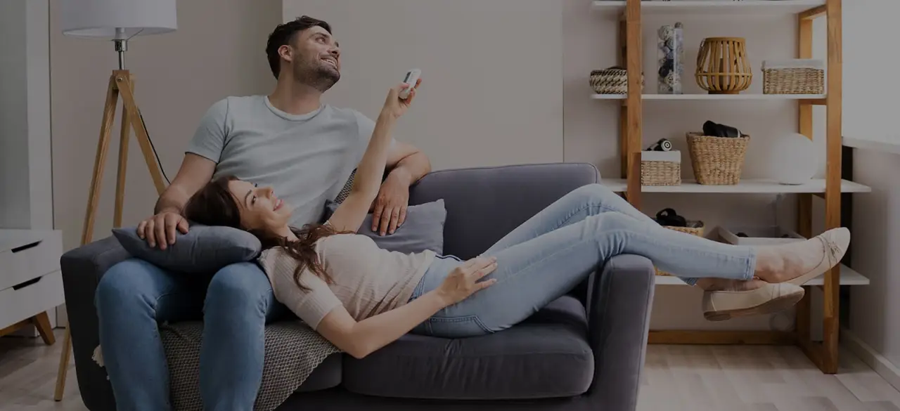 man and woman laying on couch