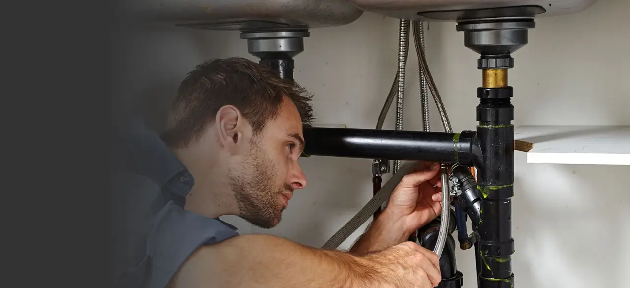 plumber fixing sink drain