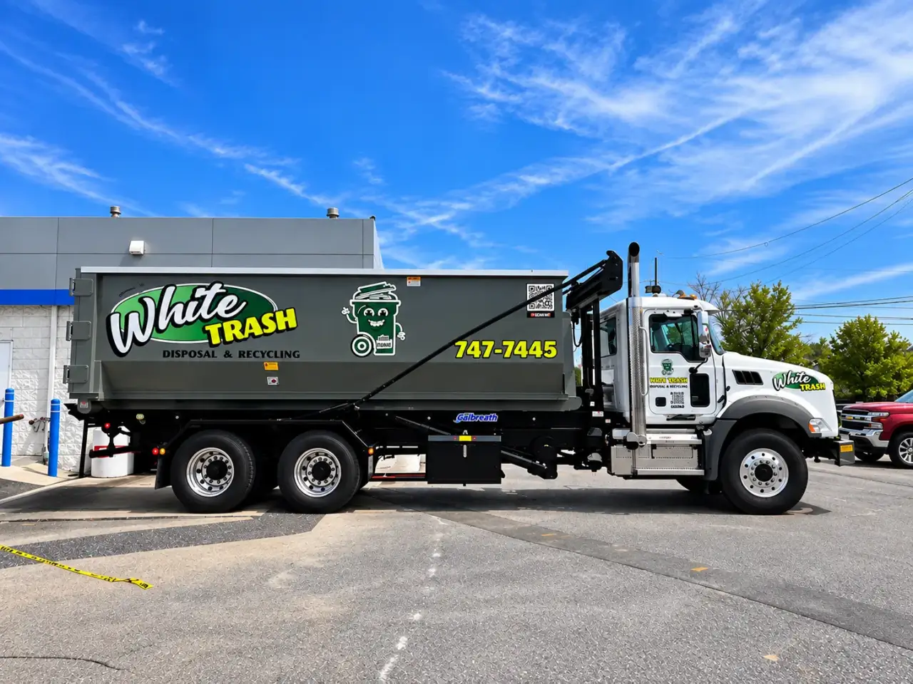 White Trash disposal and recycling truck parked in a lot.