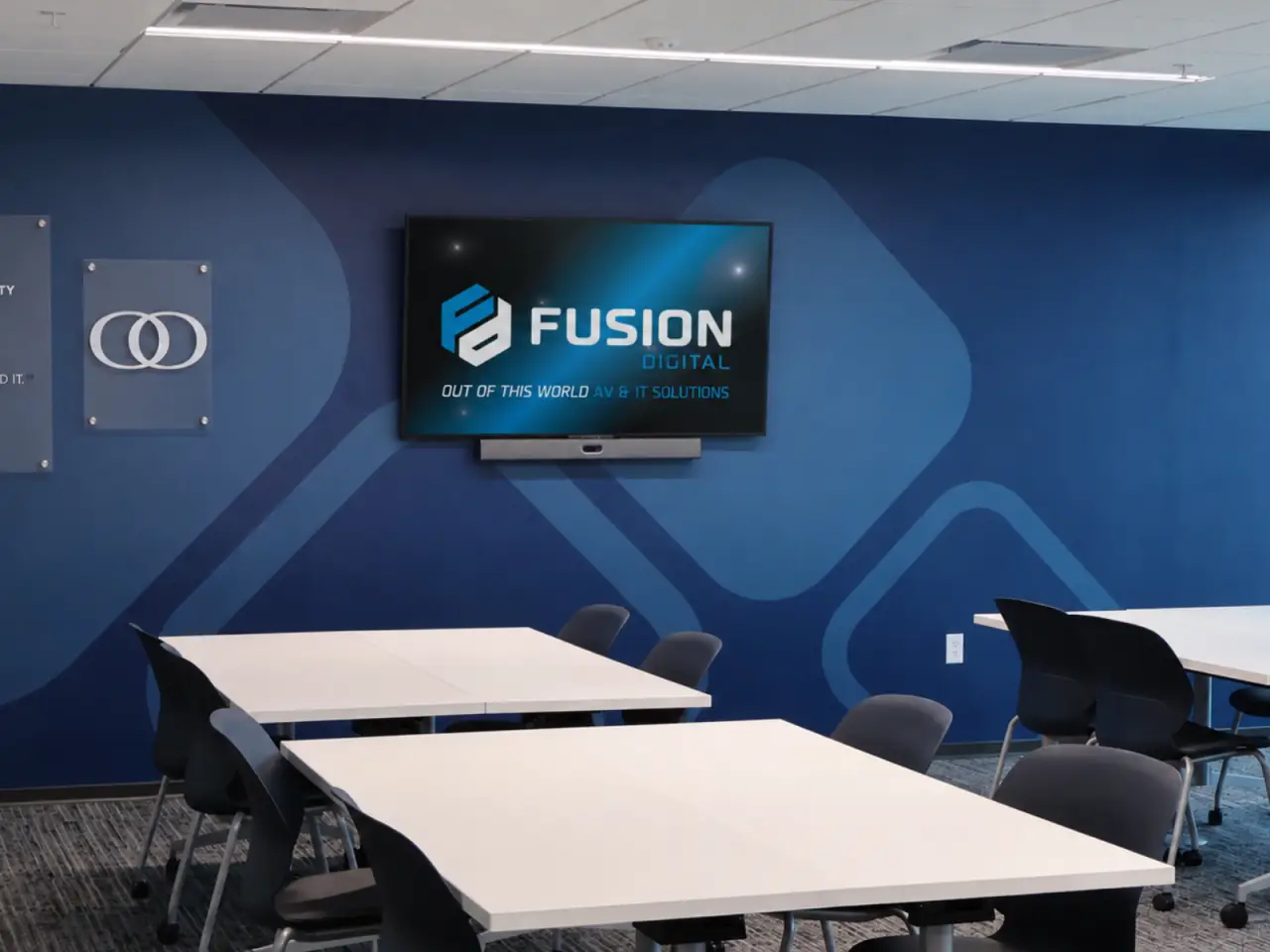 Bank headquarters meeting room with a wall-mounted display and conferencing system by Fusion Digital.