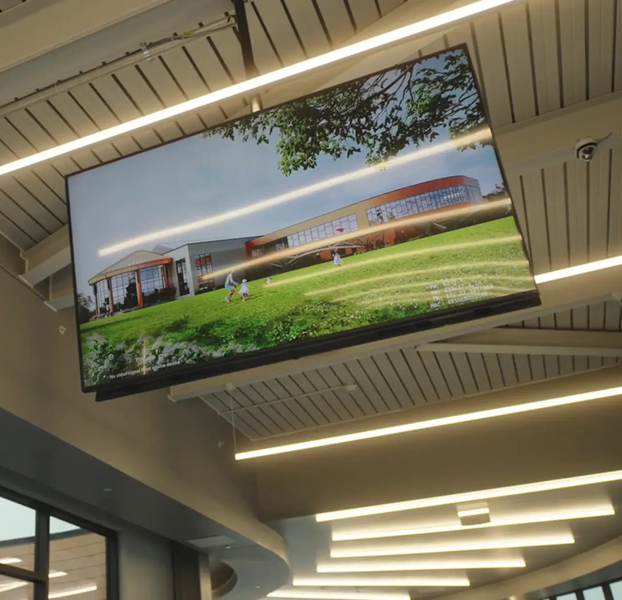 Fusion Digital digital display at the Greece Community Center showing an exterior view of the building and lawn