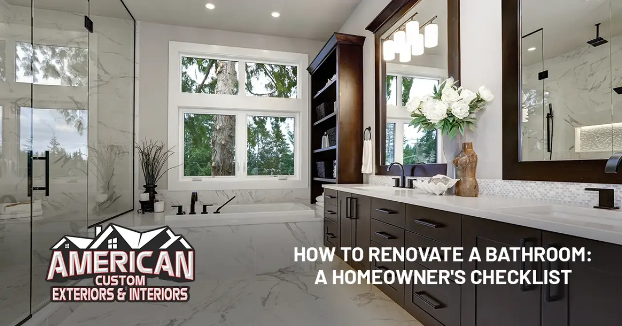 Modern bathroom with large mirrors, double sinks, a bathtub, and trees visible through windows.