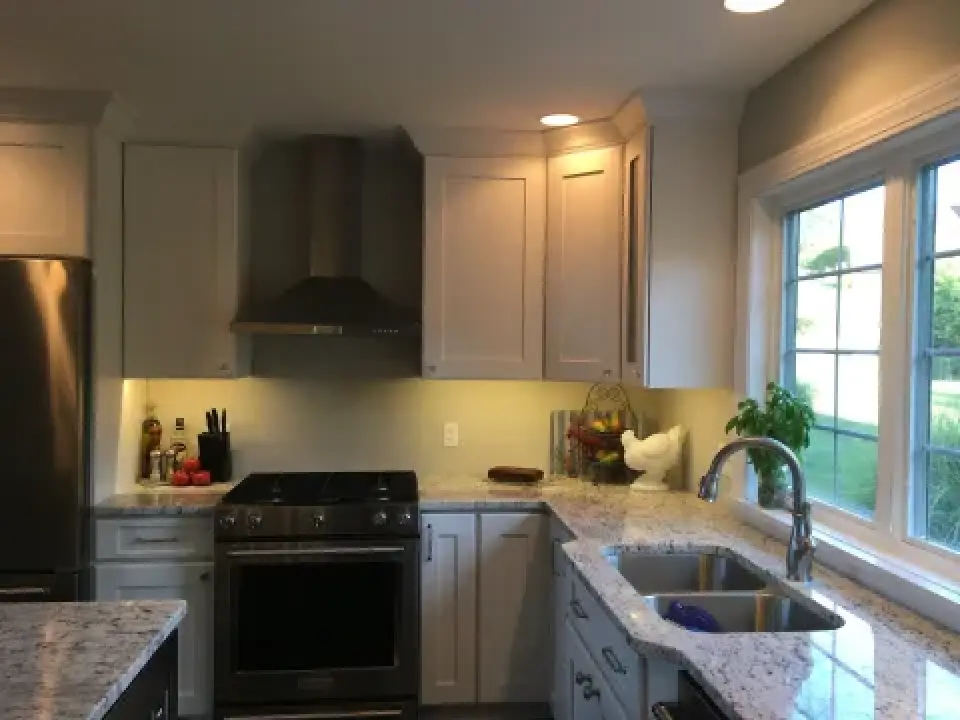 Modern kitchen with stainless steel appliances, granite countertops, and a window over the sink.