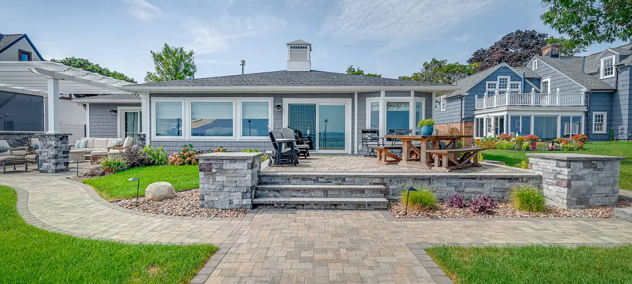 The exterior of a home with a new stone porch and patio.