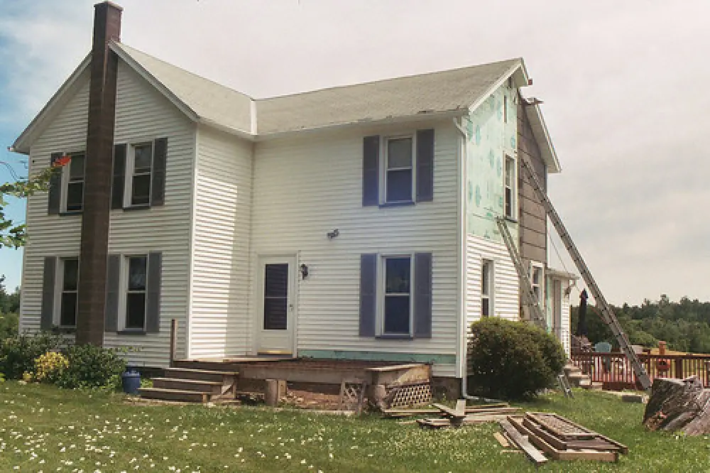 home addition work on large white house by american custom inc