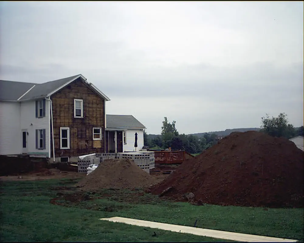 white house with broken ground for construction