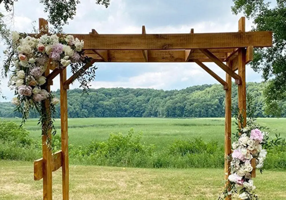wooden ceremony trellis with flowers