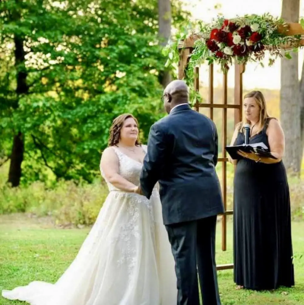 bride and groom with officiant