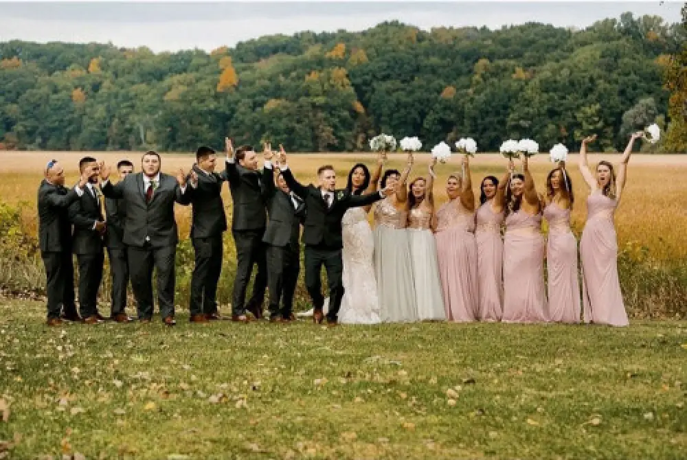 bridal party raising hands in air