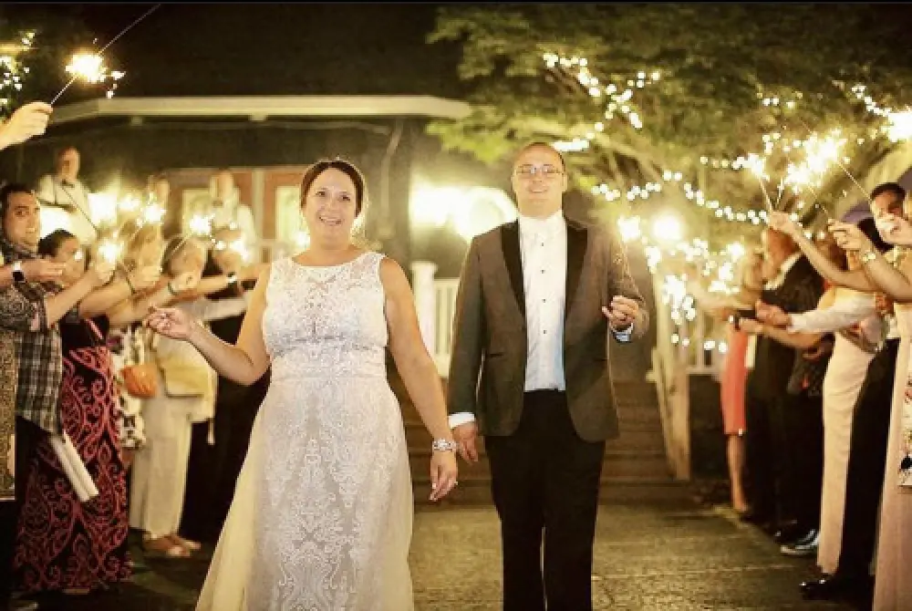 bride groom walking under sparkler exit