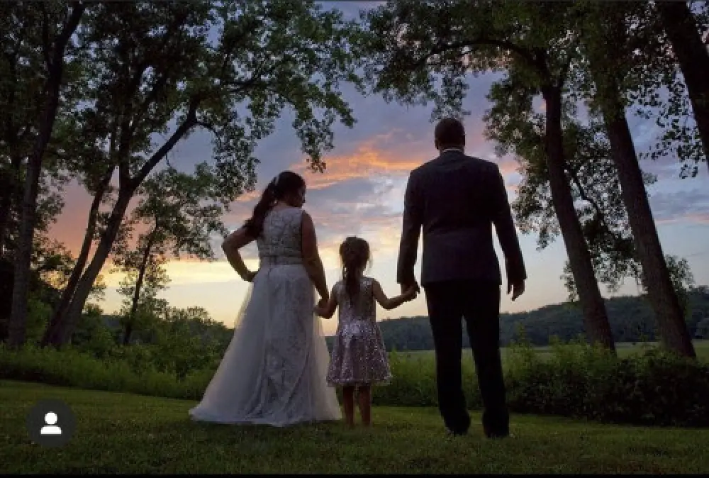 bride groom flower girl holding hands