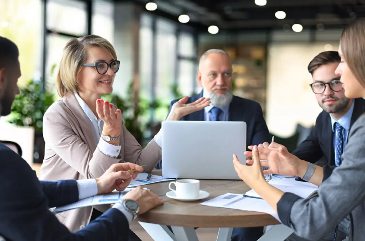 group of people talking around table