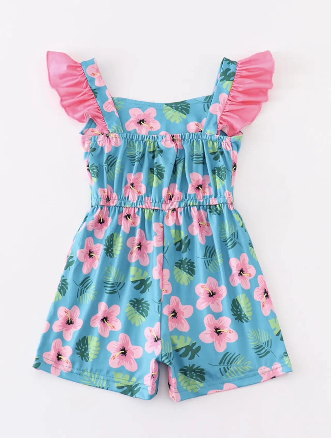 Turquoise romper with hot pink hibiscus flowers and palm leave