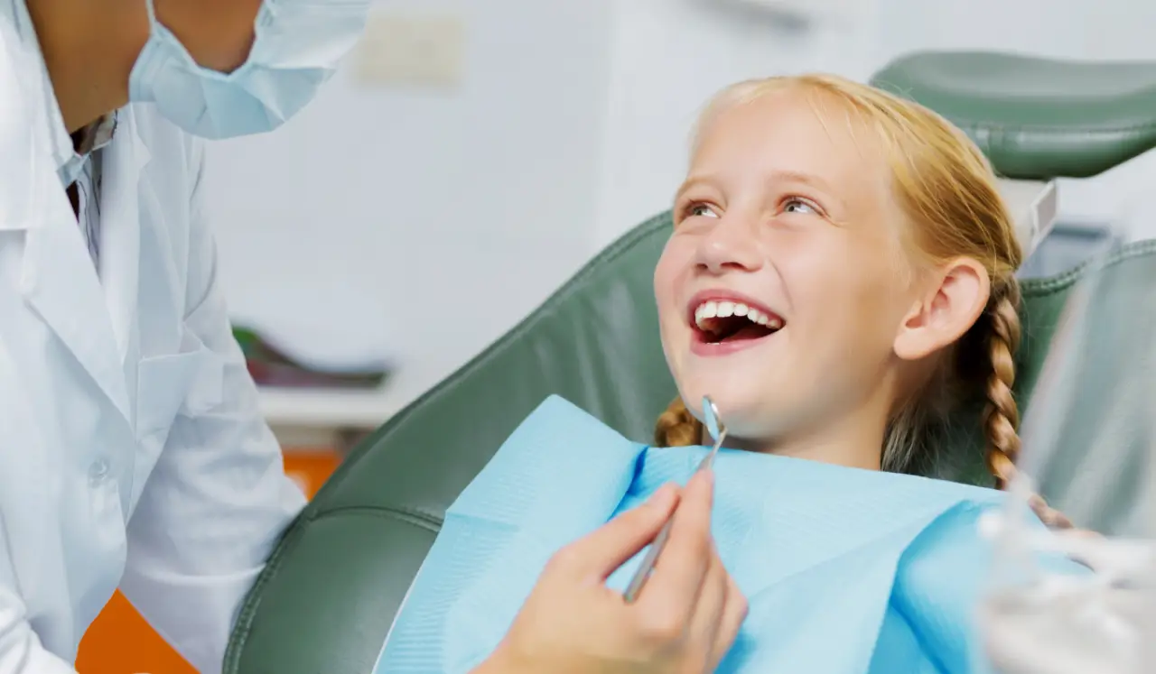 Child receiving a pediatric dental exam to check their teeth and gums.