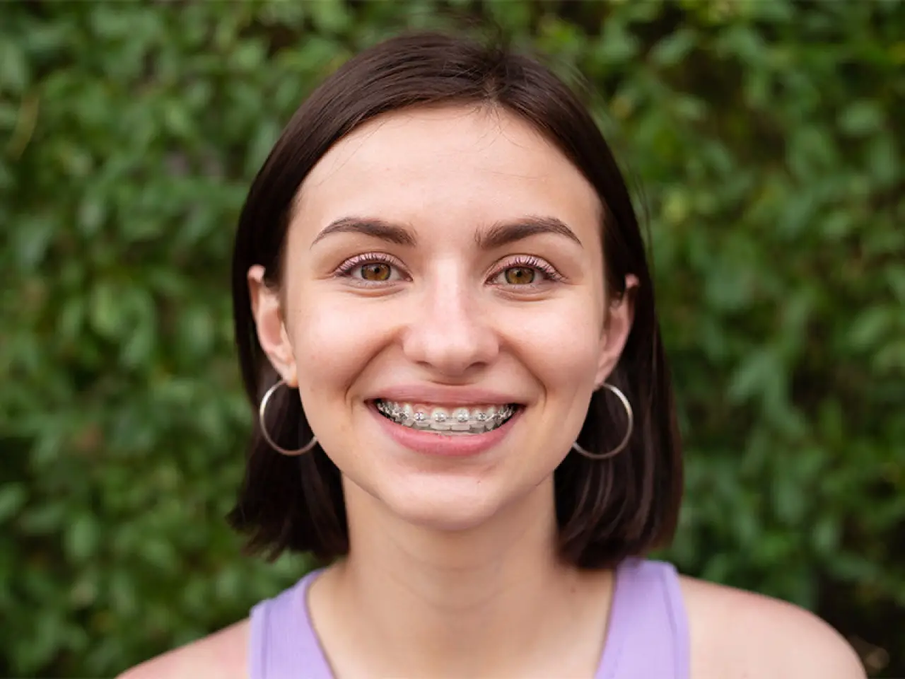 Teenage girl smiling and wearing braces.