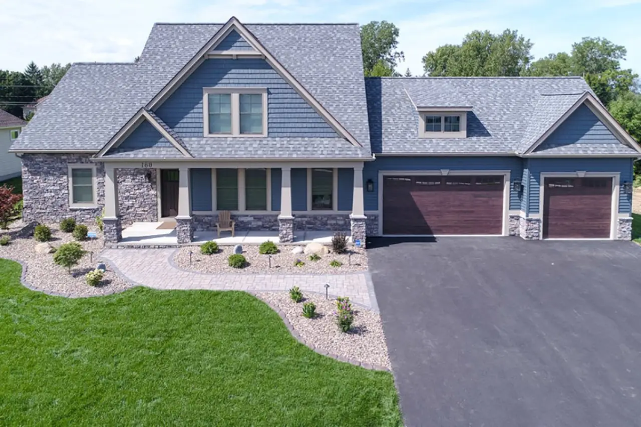 Front exterior of a beautiful custom home with 3-car garage built by Sortino Properties in Rochester NY.