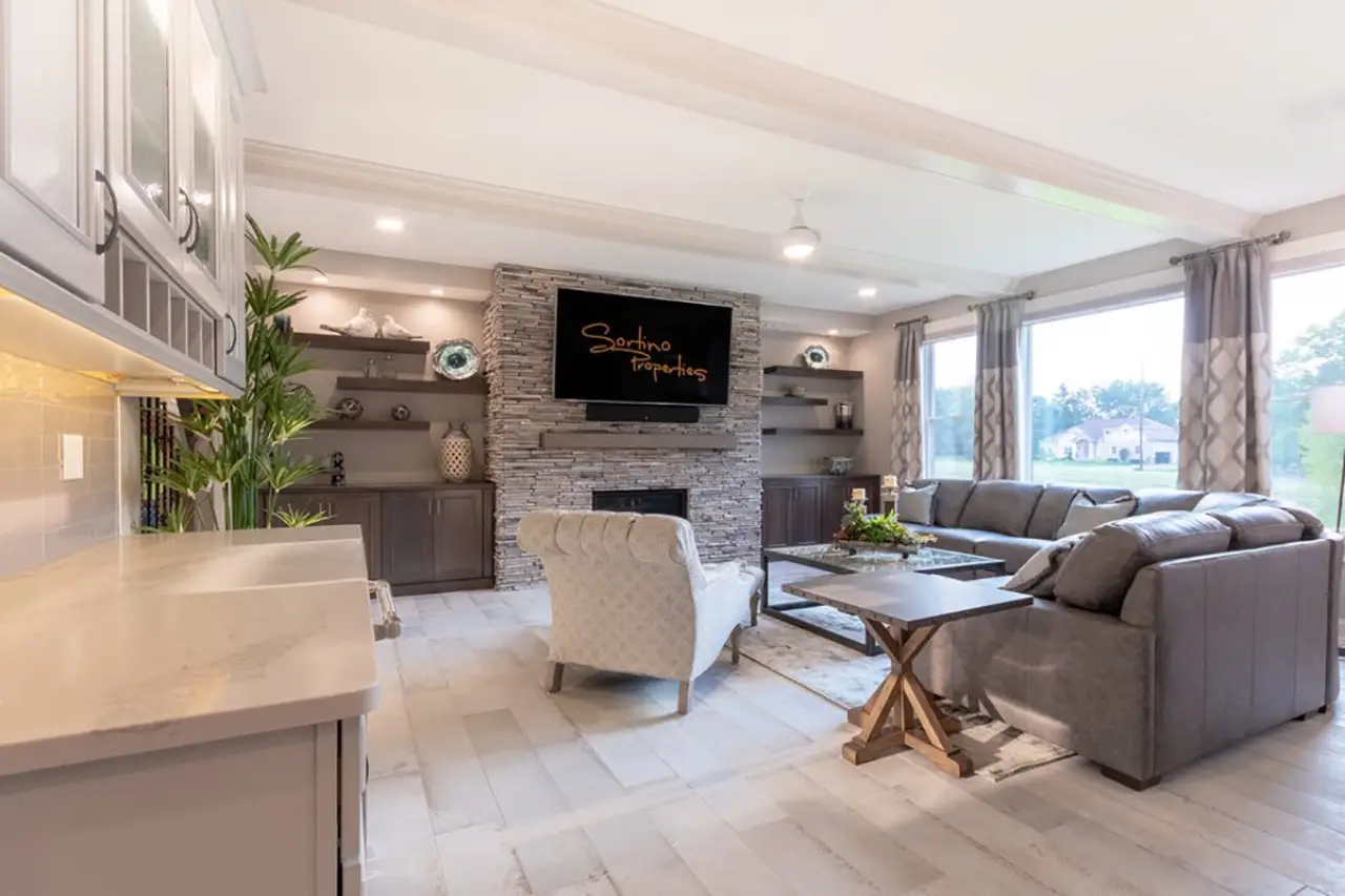 Living room with gorgeous stone fireplace in a custom built home by Sortino Properties in Rochester NY.