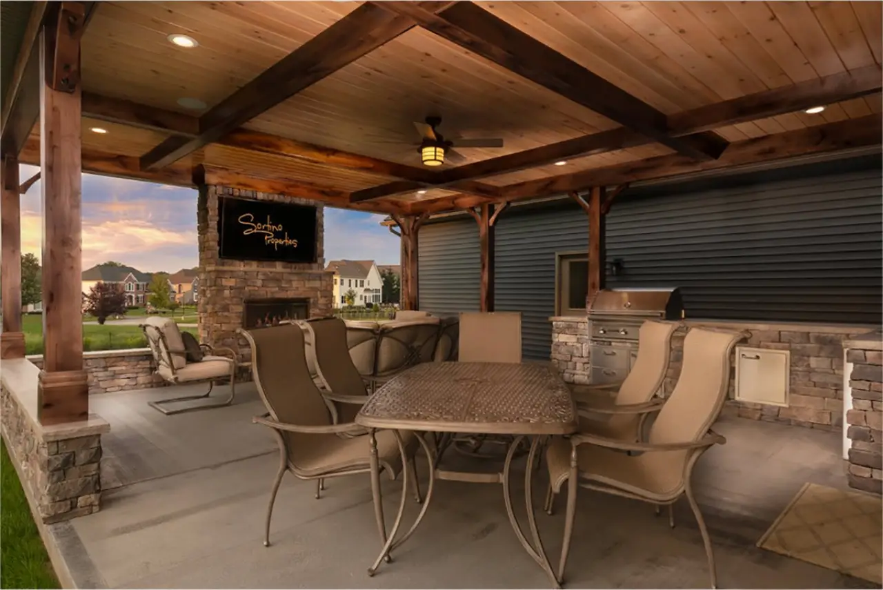 Covered back patio with outdoor television in a stunning custom built home by Sortino Properties in Rochester NY.