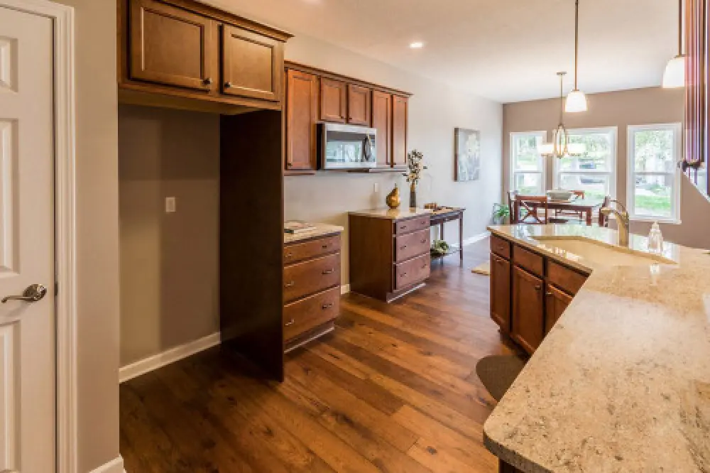 New kitchen with hardwood floors in a Villas at Churchville ranch home by Sortino Properties.