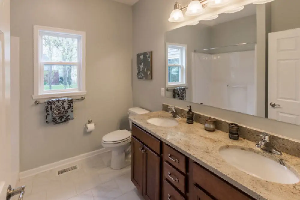 Bathroom with double vanity in a Villas at Churchville ranch home by Sortino Properties.
