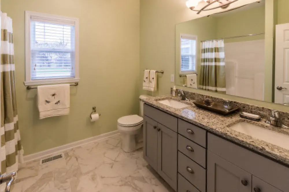 Bathroom with light green walls in a new Monarch Manor townhome by Sortino Properties in Farmington NY.