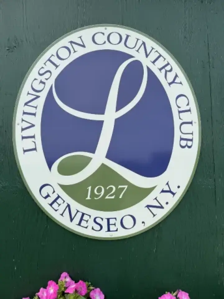 Round sign for Livingston Country Club, Geneseo, NY, 1927, with pink flowers below.