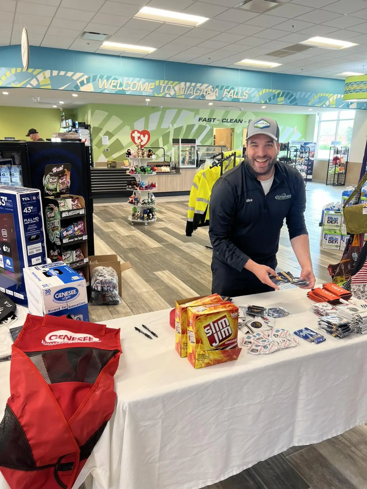 quicklee's team member stocking a table with promotional items