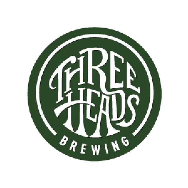 Three Heads Brewing logo with stylized white text inside a green circular border.