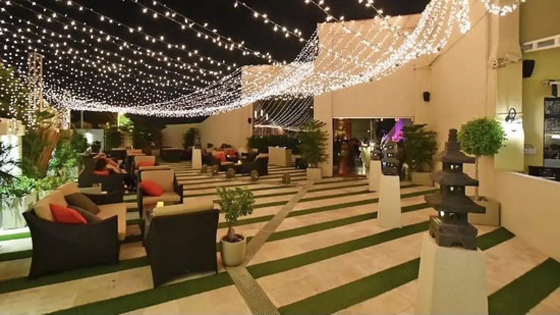 a lobby with a large chandelier and a large green lawn