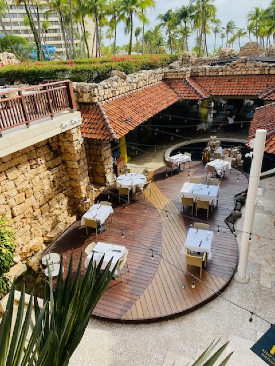 a patio with tables and chairs