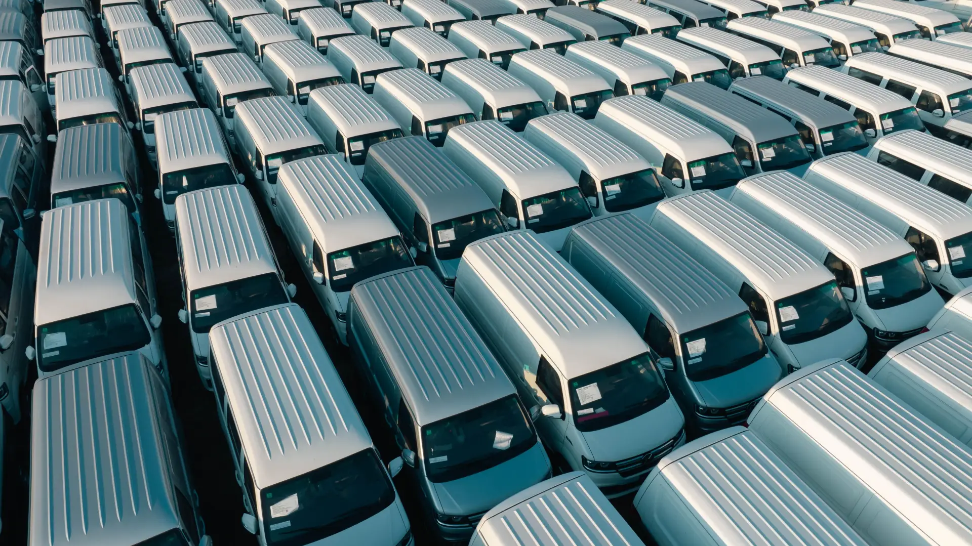 Fleet of white commercial vans lined up and ready for the road