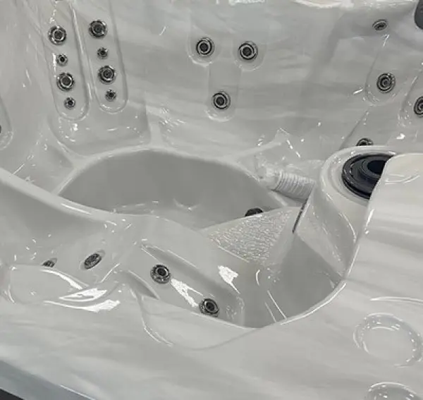 Clean white hot tub interior with hydrotherapy jets