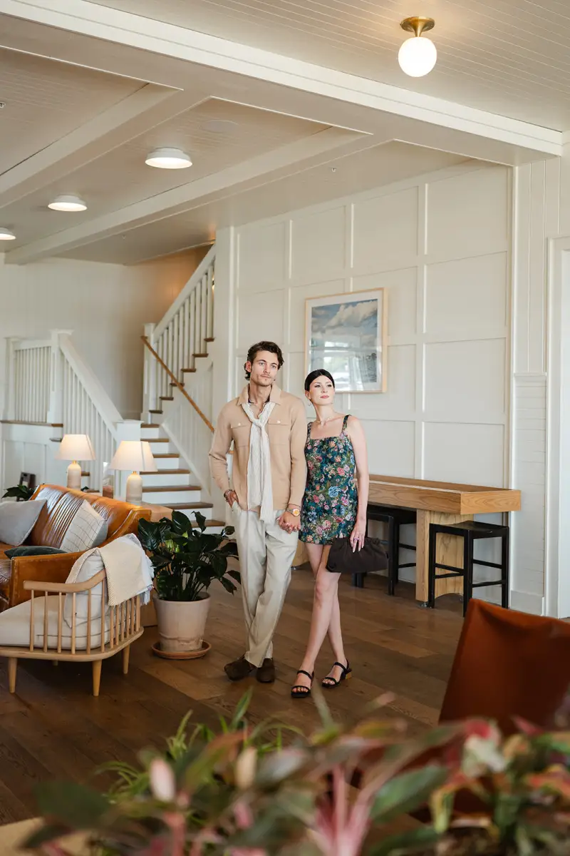 Couple in Adrian Jules custom menswear in The Lake House lobby in Canandaigua, New York