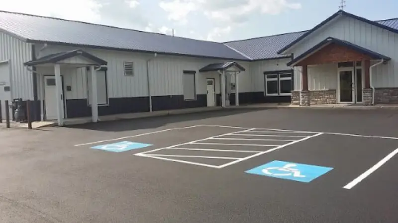 Freshly paved and striped commercial parking lot with accessible parking spaces