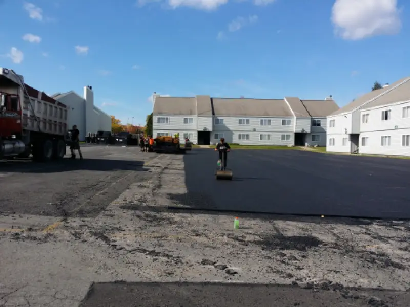 Commercial asphalt parking lot being paved