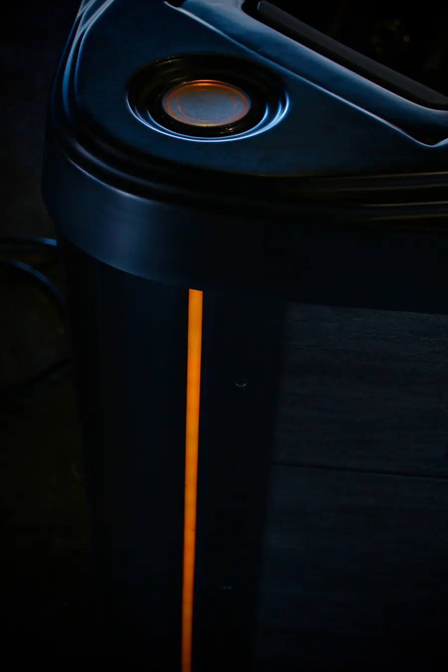 Close-up of the amber LUMINX corner light glowing on a Midnight cabinet