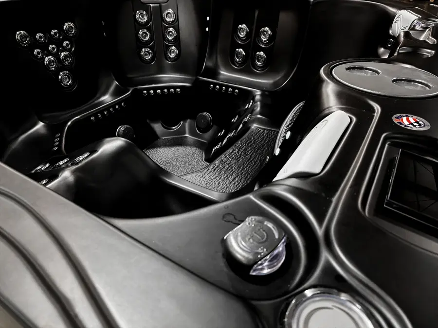Bold Luxurious Black acrylic shell with hydrotherapy jets, cup holder, and control detail
